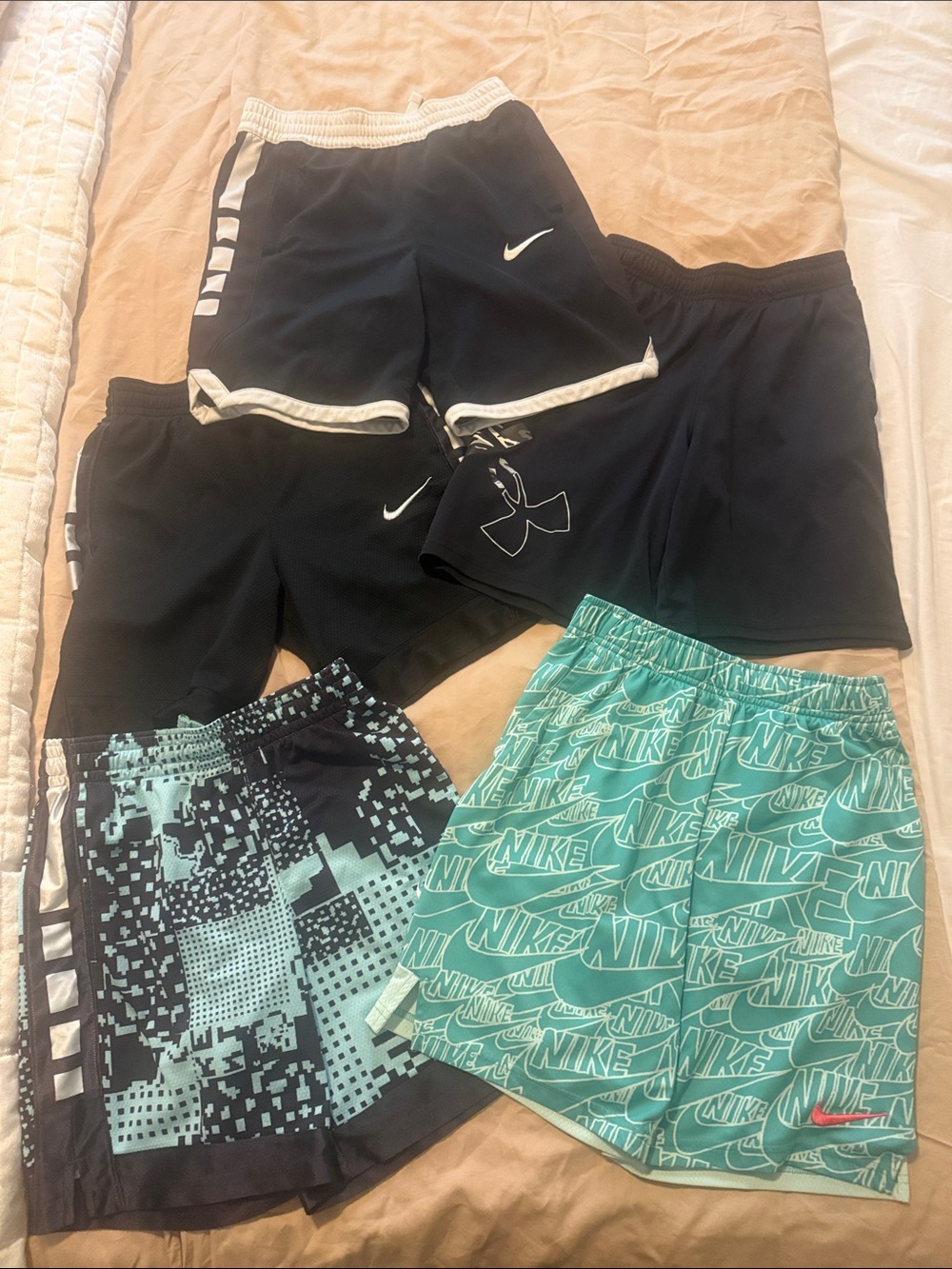 Kids shorts. 4 Nike and 1 under armour. Size medium